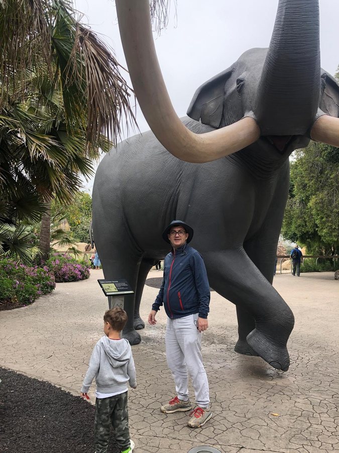 Levent Kutlu with his child beside a life-size mammoth exhibit
