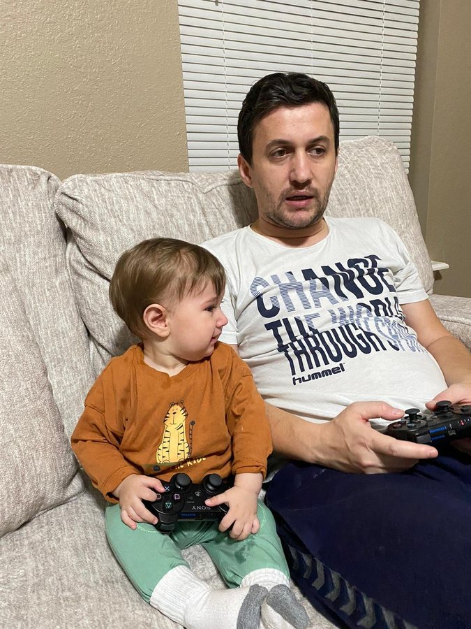 Levent Kutlu playing video games with his child